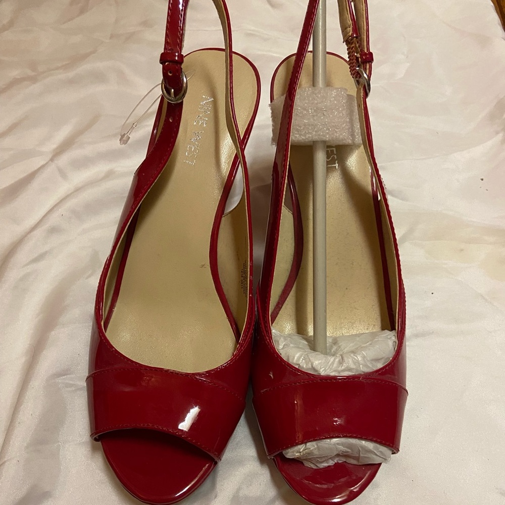Nine West open toed red patent leather heels.